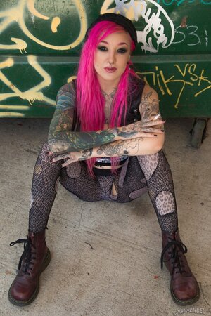 Kelsi Lynn shows off her petite ass and pussy beside the dumpster while smoking