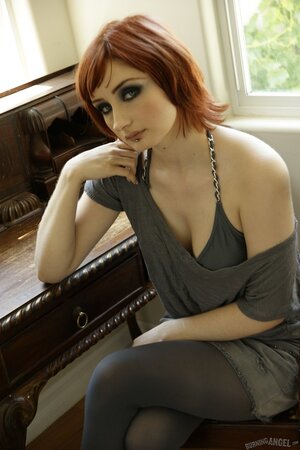 Violet Monroe sucks and toys her blue dildo in the window