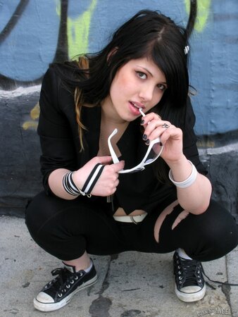 Fetish doll spreads legs and poses naked in alleyway with sunglasses