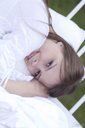 Beata Undine poses seductively on the outdoor day bed after stripping