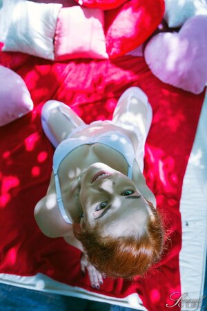 Hot redhead Red Linx enjoys taking off her white lingerie and revealing her tiny pussy