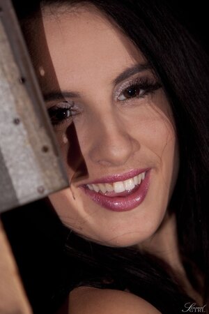 Playful brunette with an athletic body gropes her big breasts