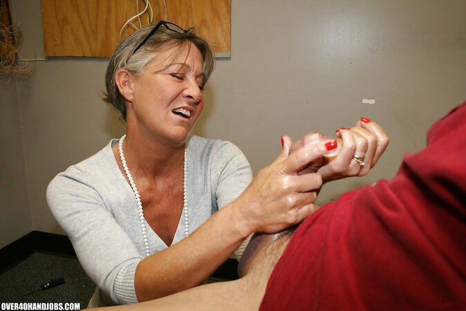 Naughty mature lady Leilani Li enjoys sensually jerking off a big cock