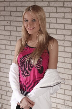 Young-looking blonde girl Logan enjoys modeling nude with her pretty face and perfect ass