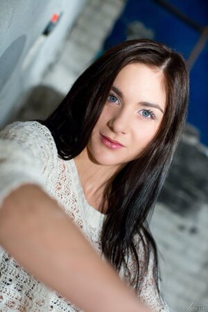 German stunner Lullu Gun strips down to her knee-high socks on a throw rug