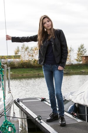 Beautiful chick is masturbating and sunbathing on top of the roof