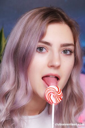 Eva Elfie enjoys stripping to her socks and toying her bald pussy