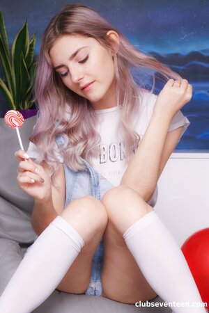 Eva Elfie enjoys stripping to her socks and toying her bald pussy