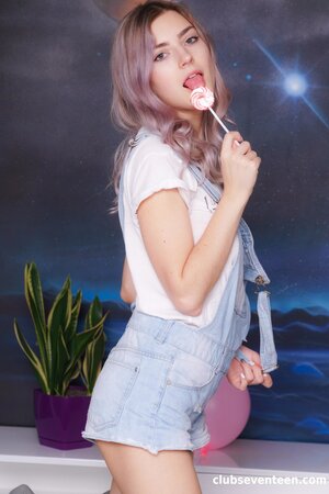 Eva Elfie enjoys stripping to her socks and toying her bald pussy