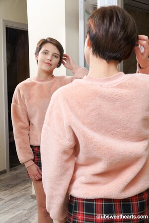 Short-haired teen Alex Swon exposes her bald cunt and rubs it while wearing red socks