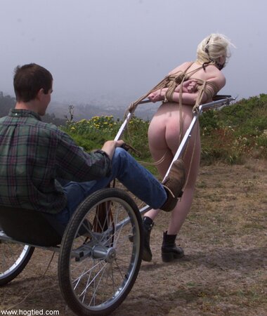 Cowgirl gets whipped while dragging her master up a hill