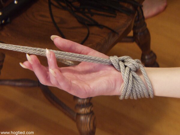 Her legs spread as wide as possible as she gets whipped