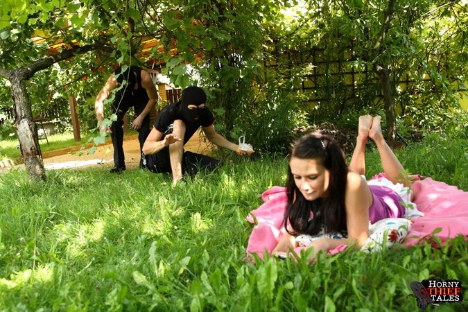 Brunette Klara gets spit-roasted by masked men outdoors