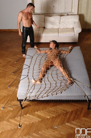 Teases her clit with feather-light touches before fucking her