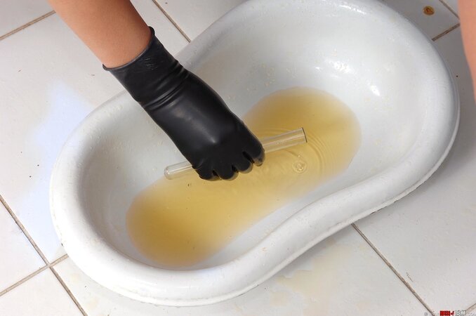 Stretches her labia and pisses her pussy off with a BDSM domme