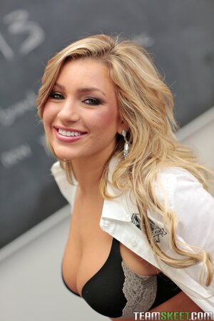 Smiling minx with superb body shows off while in class