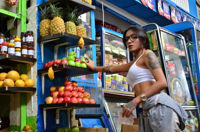 Tattooed Marly Romero licks banana naughty in public