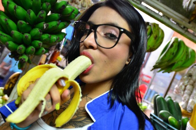 Tattooed Marly Romero licks banana naughty in public