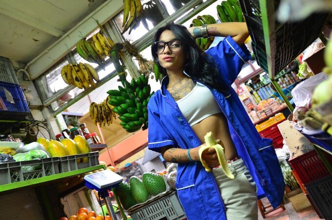 Tattooed Marly Romero licks banana naughty in public