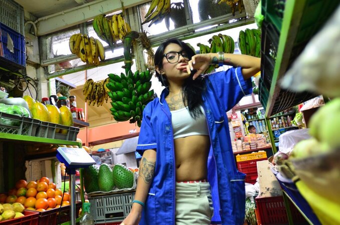 Tattooed Marly Romero licks banana naughty in public