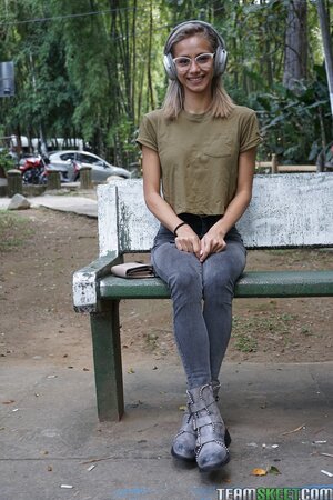 Veronica Leal poses on hood in green shirt and tight jeans