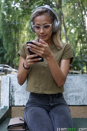 Veronica Leal poses on hood in green shirt and tight jeans