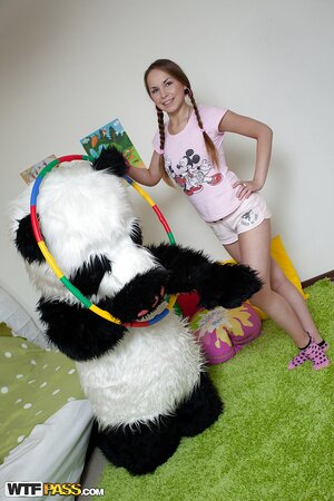 Sweet babe in shorts fun with big panda toy