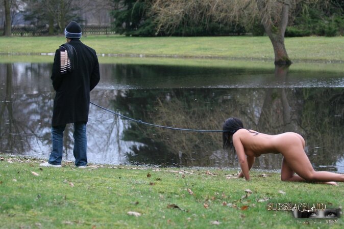 Master walks with dominated nude brunette on a leash and ties her up to the tree