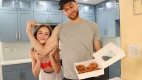 Daisy Fox playing with donuts and her muscular partner